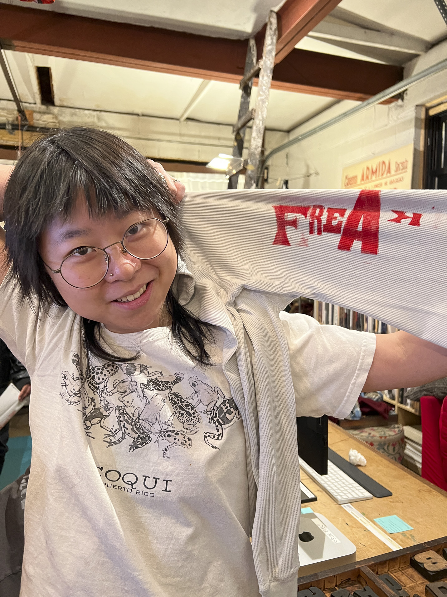 Tisch student holding a print made with hand-set type